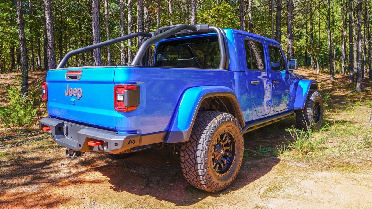 blue jeep gladiator with a fab fours sports rack featured on the buyers' guide for sports rack trucks