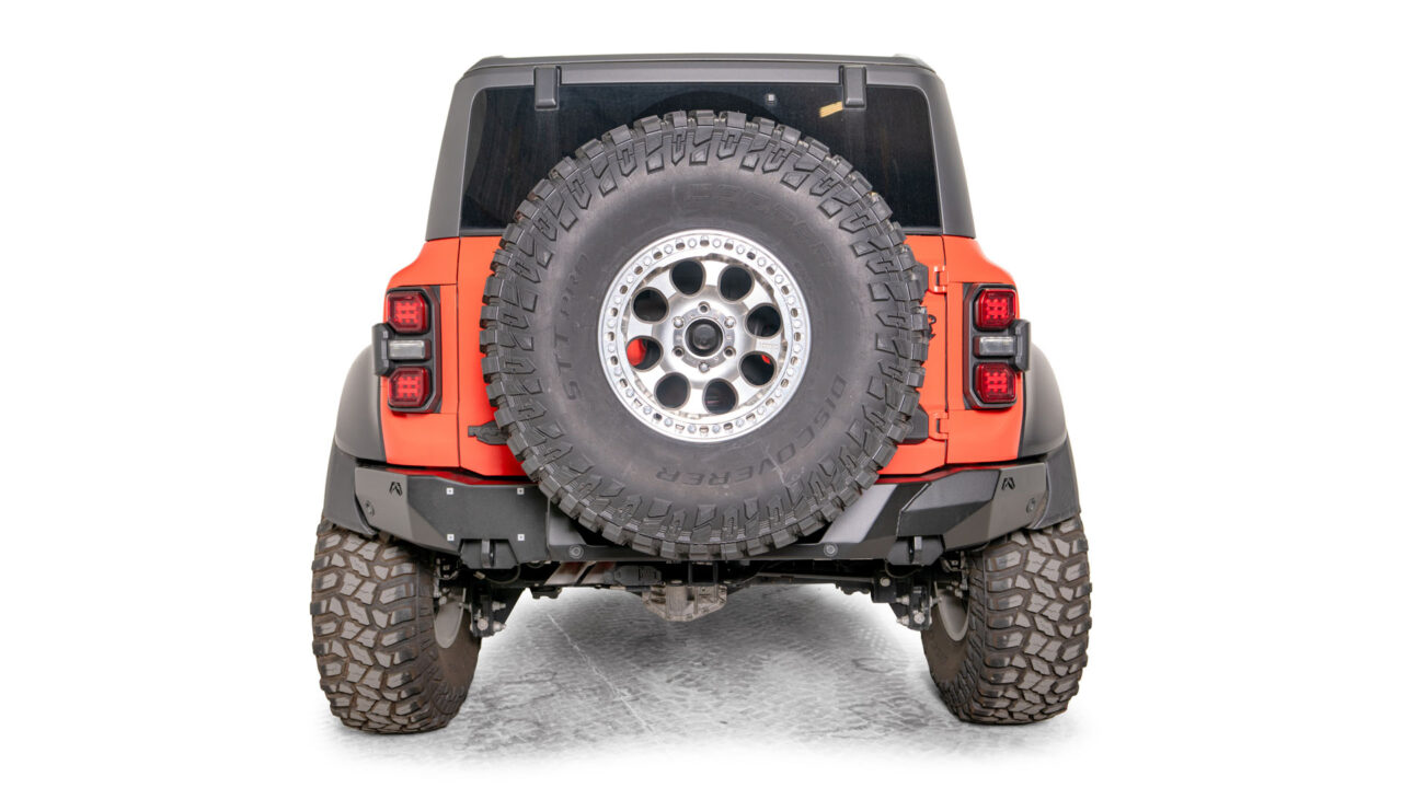 This image showcases a high-performance rear bumper tailored specifically for Ford Bronco Raptors. The sleek and durable design of this premium bumper complements the Bronco's off-road capabilities seamlessly. With integrated LED lights for enhanced visibility and safety, this bumper offers exceptional functionality and protection. The Fab Fours logo prominently displayed on the bumper represents the brand's commitment to quality and innovation. Elevate your Ford Bronco Raptor with this top-tier rear bumper, enhancing both its aesthetic appeal and off-road performance for unforgettable adventures.